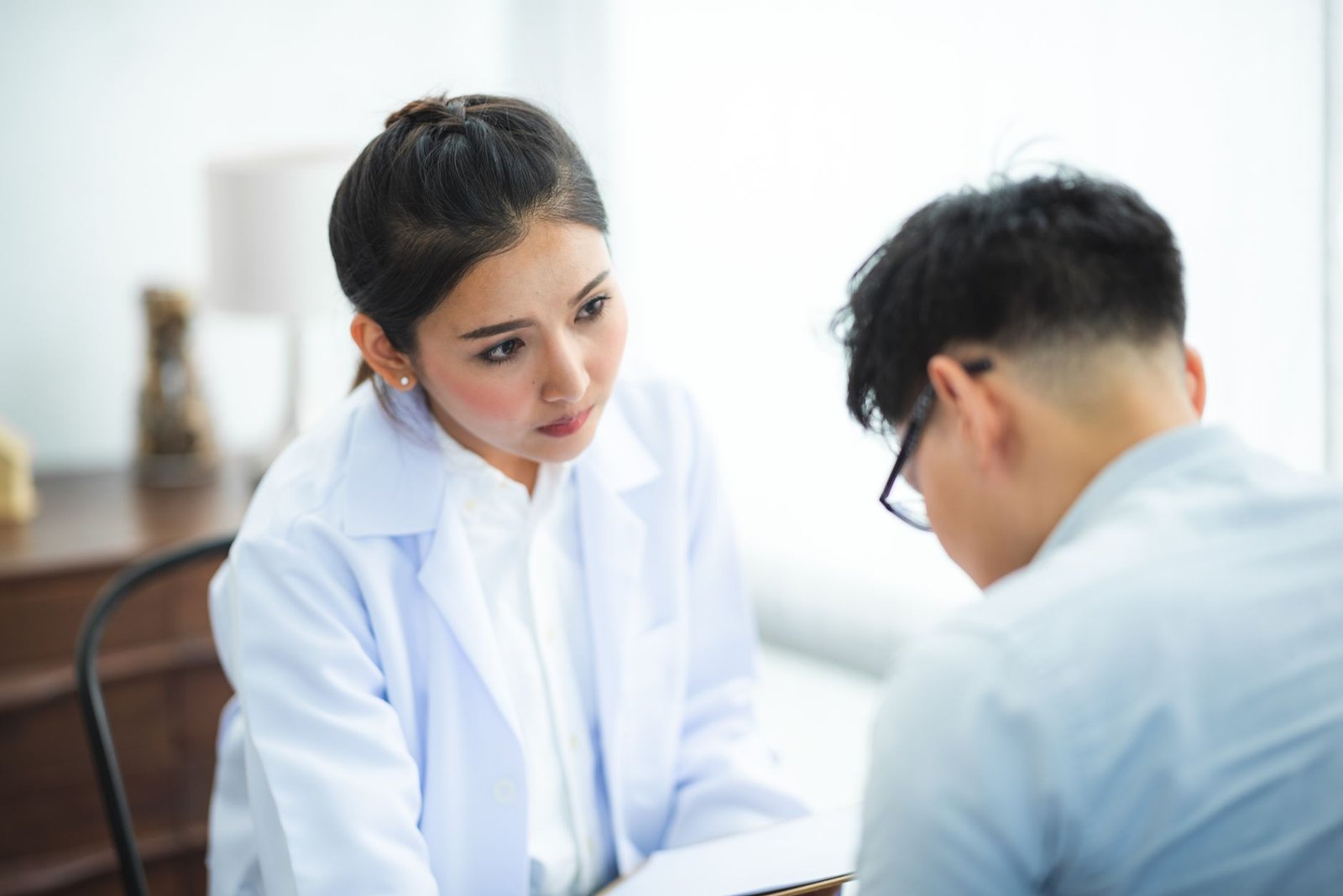 A doctor discussing cheek filler cost in the Maldives with a patient during a consultation